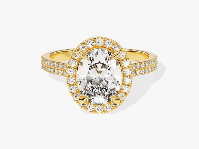 Oval lab grown diamond halo engagement ring with double row pave band in yellow gold, front view