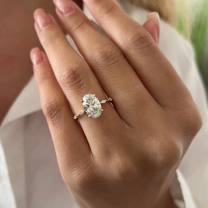 Oval cut moissanite engagement ring with marquise and round accent band in rose gold, view 2