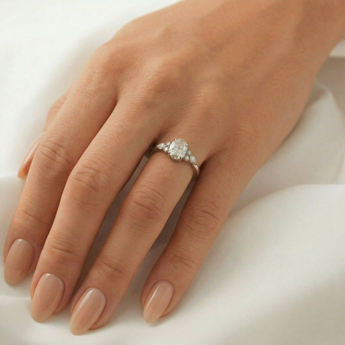 Oval cut moissanite with a pear and two rounds clustered at each shoulder in white gold, view 2