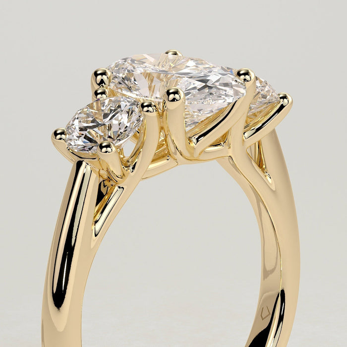 Oval cut moissanite three stone engagement ring with round side stones in yellow gold, view 2
