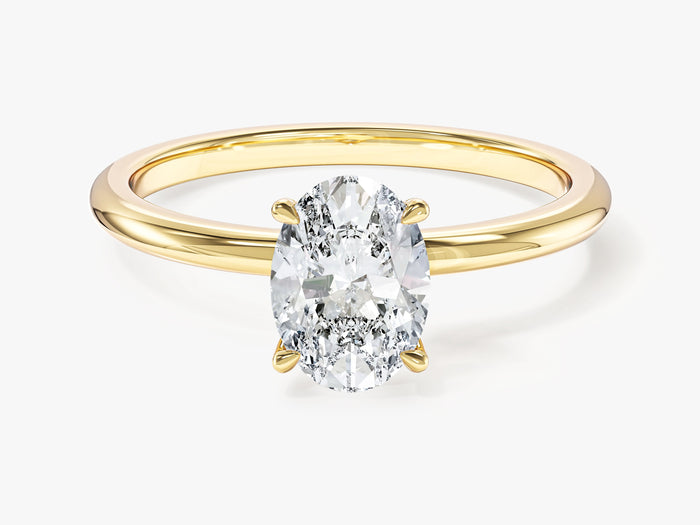 Dainty oval lab grown diamond solitaire engagement ring in yellow gold, front view