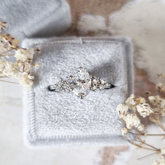 Oval cut moissanite snowdrift cluster shoulder engagement ring in white gold