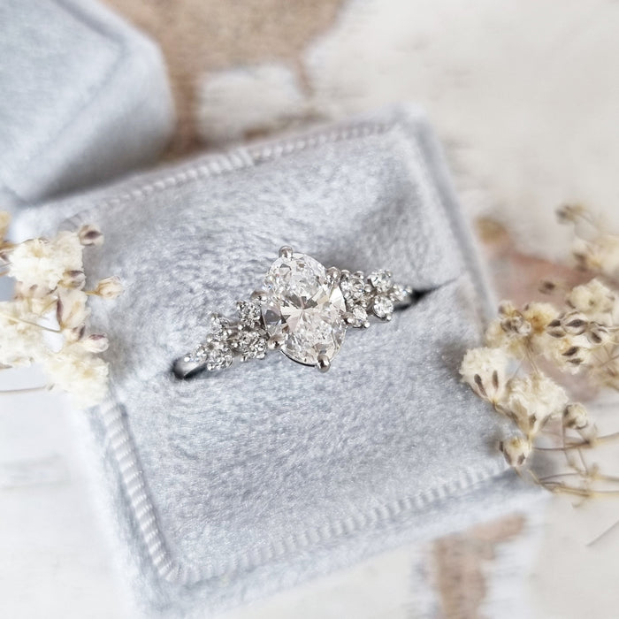 Oval cut moissanite snowdrift cluster shoulder engagement ring in white gold, view 2