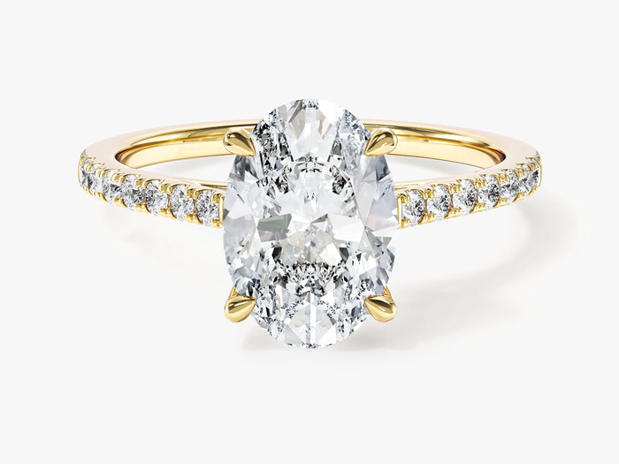 Oval lab grown diamond pave band engagement ring in yellow gold, front view showing the four claws