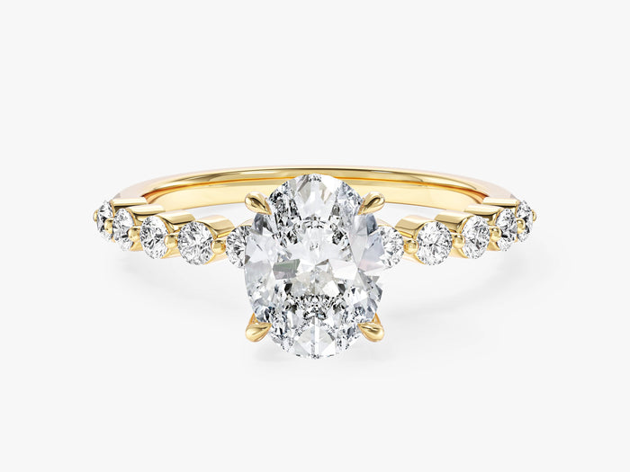 Oval lab grown diamond engagement ring with shared prong side stones in yellow gold, front view