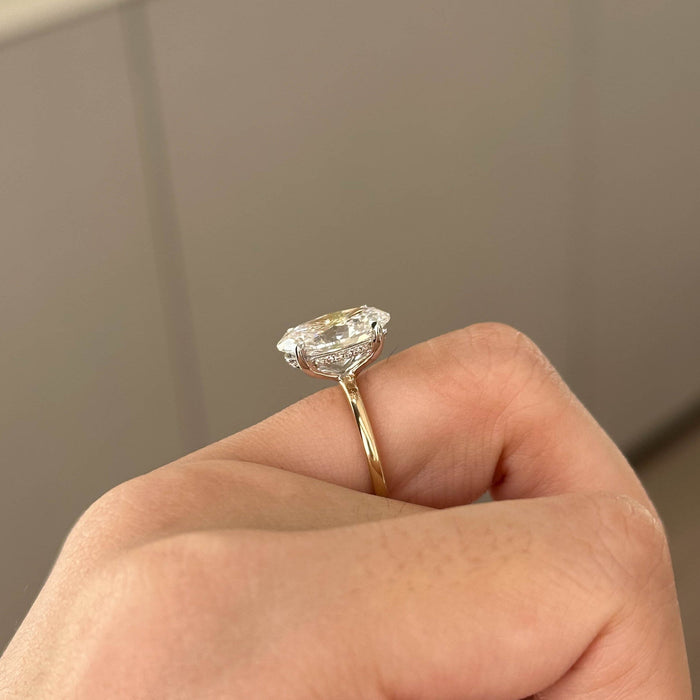 Oval cut moissanite two tone cathedral solitaire engagement ring in white and yellow gold, view 2