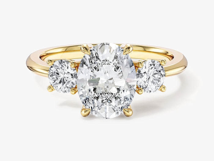 Oval lab grown diamond trilogy engagement ring with round side diamonds in yellow gold, front view