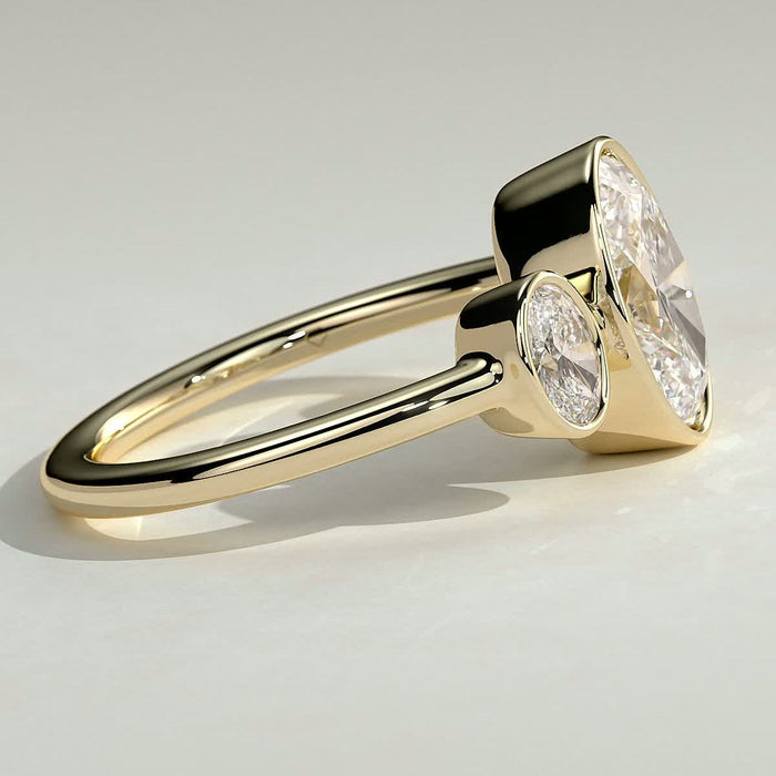 Oval cut moissanite three stone full bezel engagement ring in yellow gold, view 2