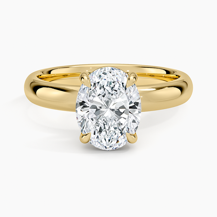 Oval moissanite solitaire on a 3 mm comfort fit yellow gold band, top view