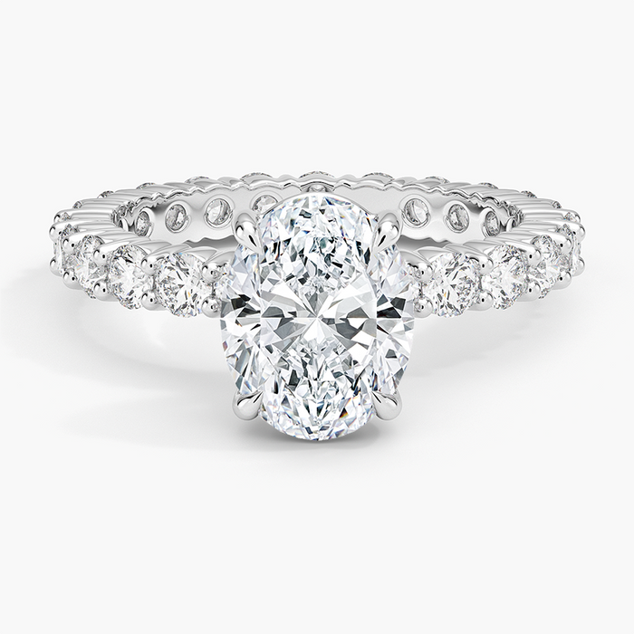 Oval moissanite engagement ring on a full eternity shared prong band in white gold, top view