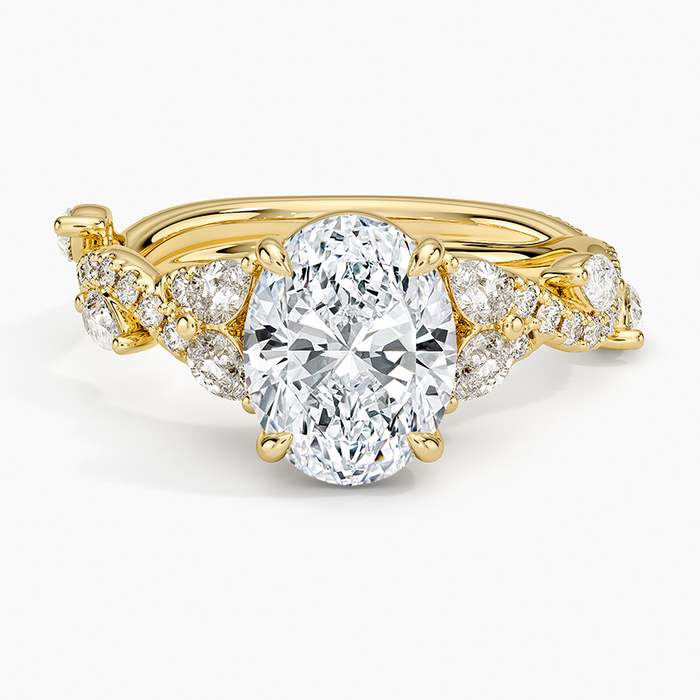 Oval moissanite with round petal clusters on a twisted yellow gold vine band, top view