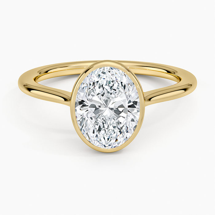 Oval moissanite in a full yellow gold bezel on a split band, top view