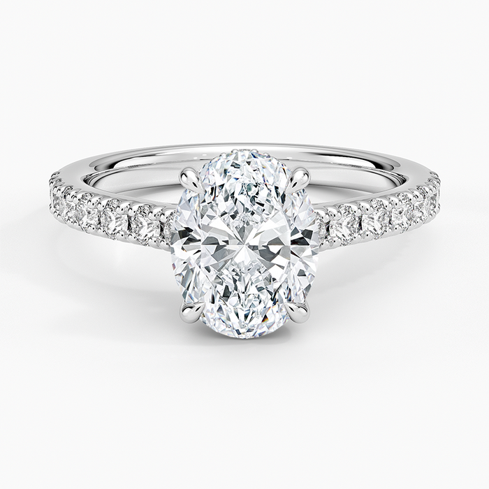 Oval moissanite ring with graduated pave shoulders in white gold, top view