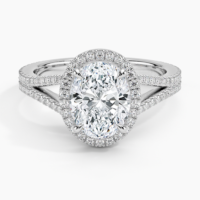 Oval moissanite with a micropave halo and pave split shank in white gold, top view