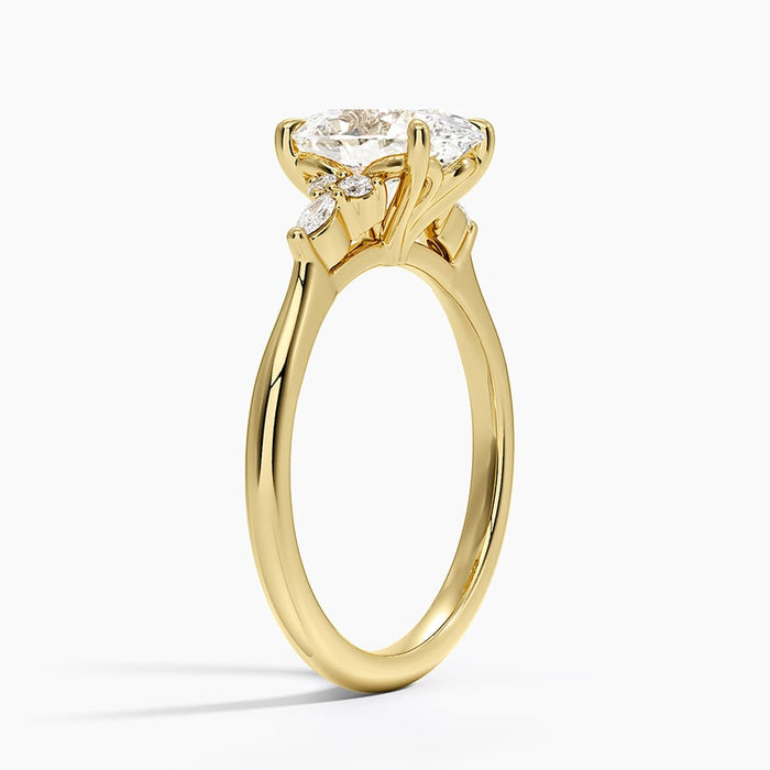 Side view of the marquise and round leaf cluster beside the oval centre stone