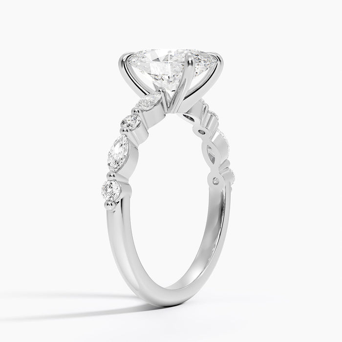 Side view showing the shared prong marquise and round accents along the band
