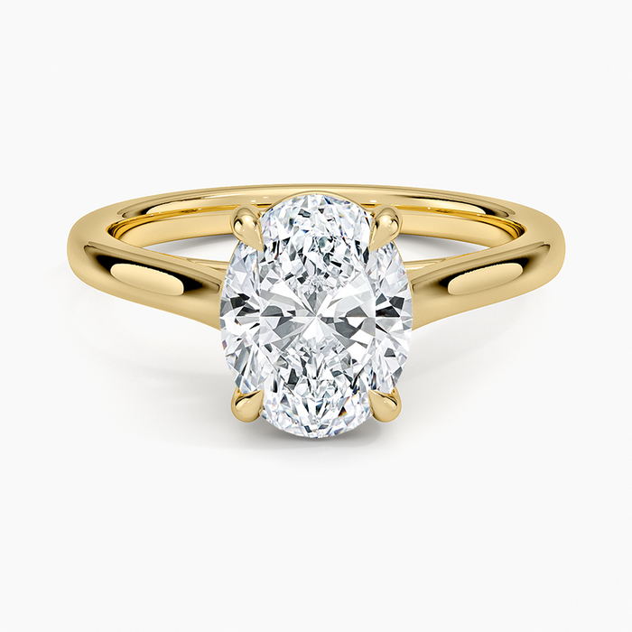 Oval moissanite solitaire on an open split shank in yellow gold, top view
