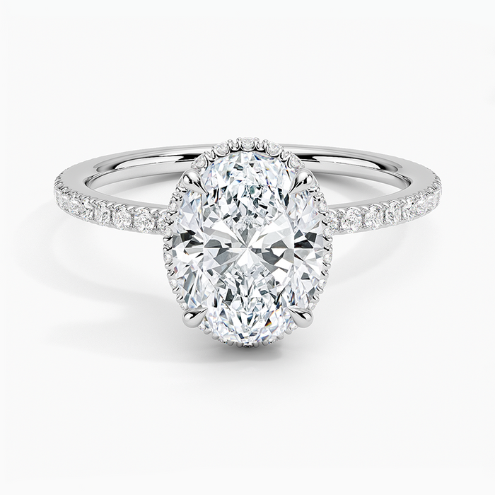 Oval moissanite with a peekaboo halo showing past the stone edge, white gold, top view