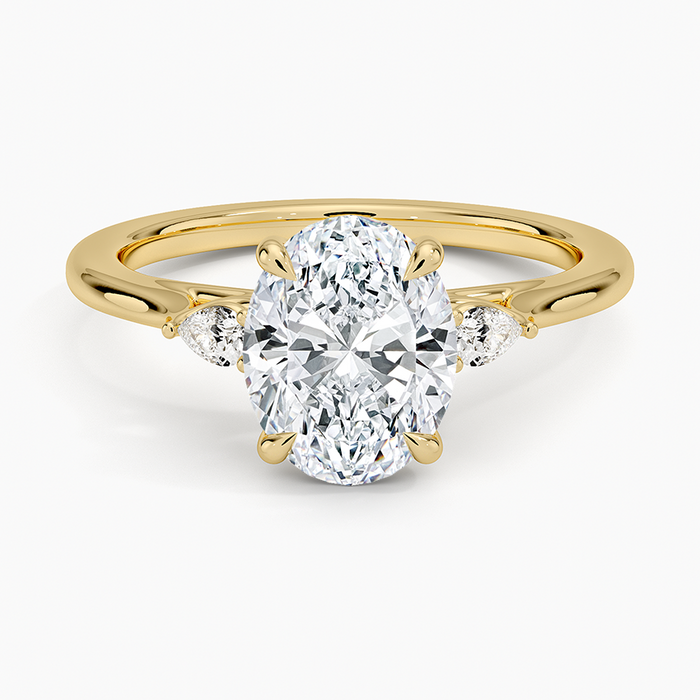 Oval moissanite perfect fit three stone pear ring in yellow gold, top view