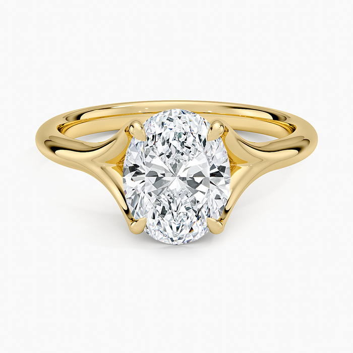 Oval moissanite solitaire on a sculpted chevron split shank in yellow gold, top view
