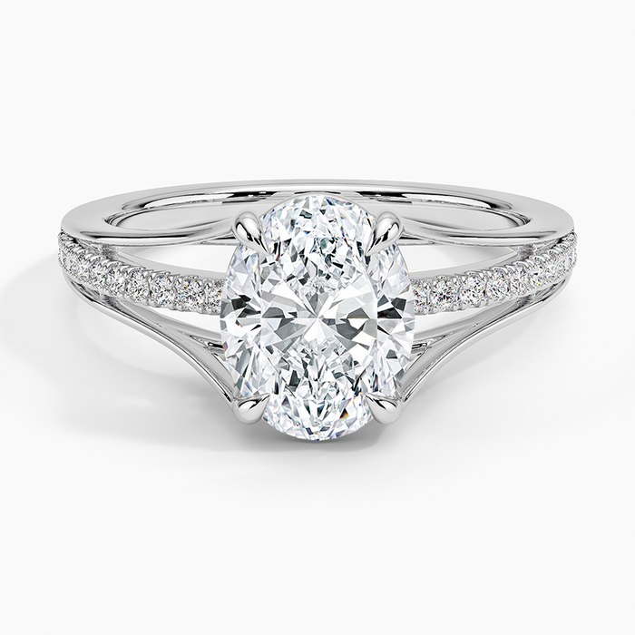 Oval moissanite with pave shoulders splitting into a plain V in white gold, top view