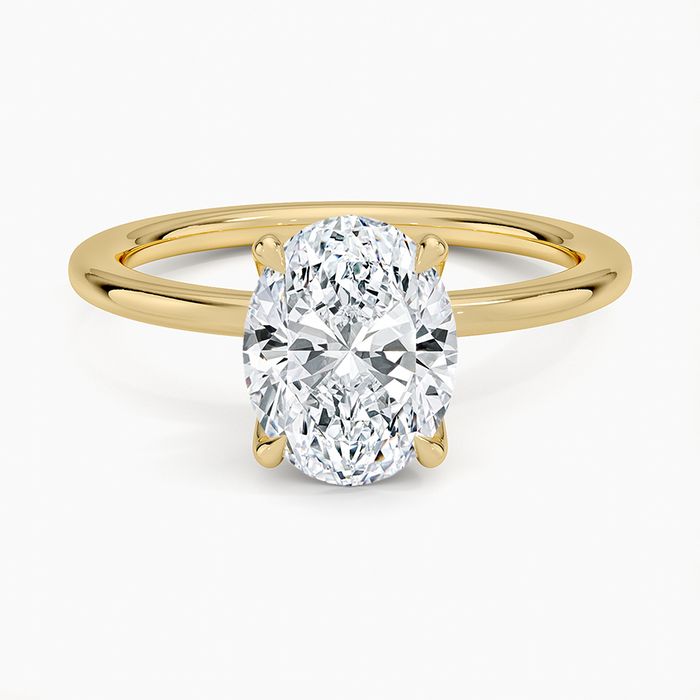 Oval moissanite thin band low profile solitaire ring in yellow gold, top view