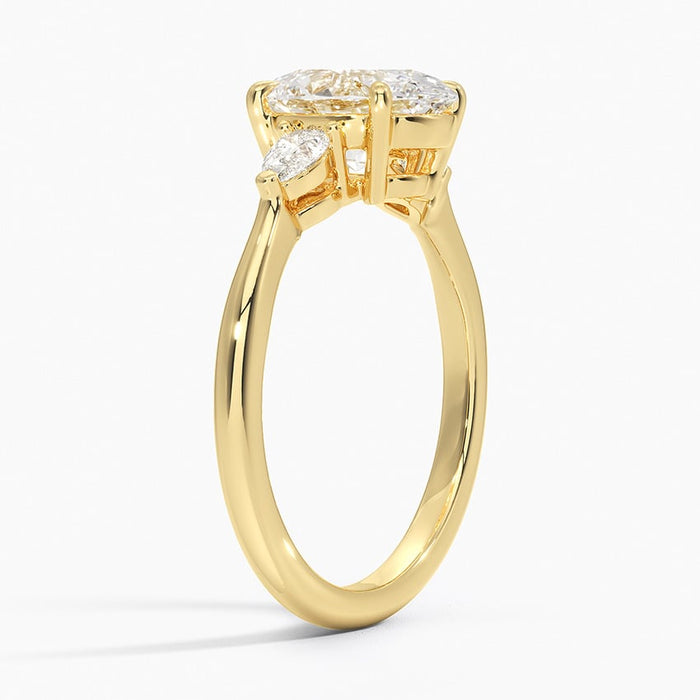 Side profile of oval moissanite three stone ring showing pear prongs and plain band
