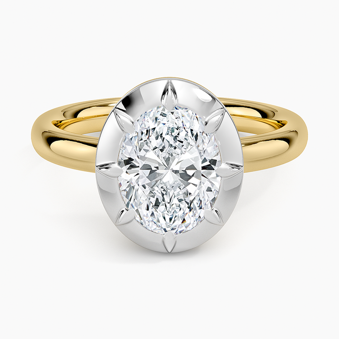 Oval moissanite in a white solid halo on a yellow gold band, top view