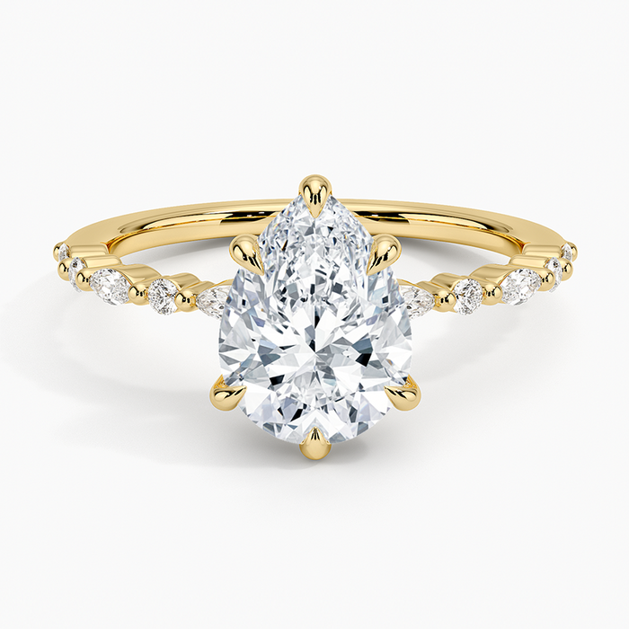 Pear cut moissanite claw set marquise and round engagement ring in yellow gold, top view