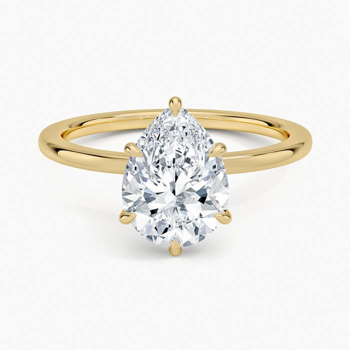 Pear cut moissanite hidden halo engagement ring in yellow gold, top view