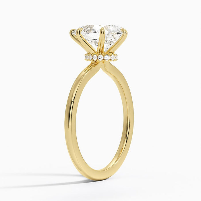 Side view showing the hidden halo of small moissanite stones under the pear centre