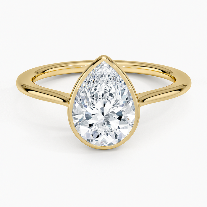 Pear cut moissanite low smooth bezel engagement ring in yellow gold, top view