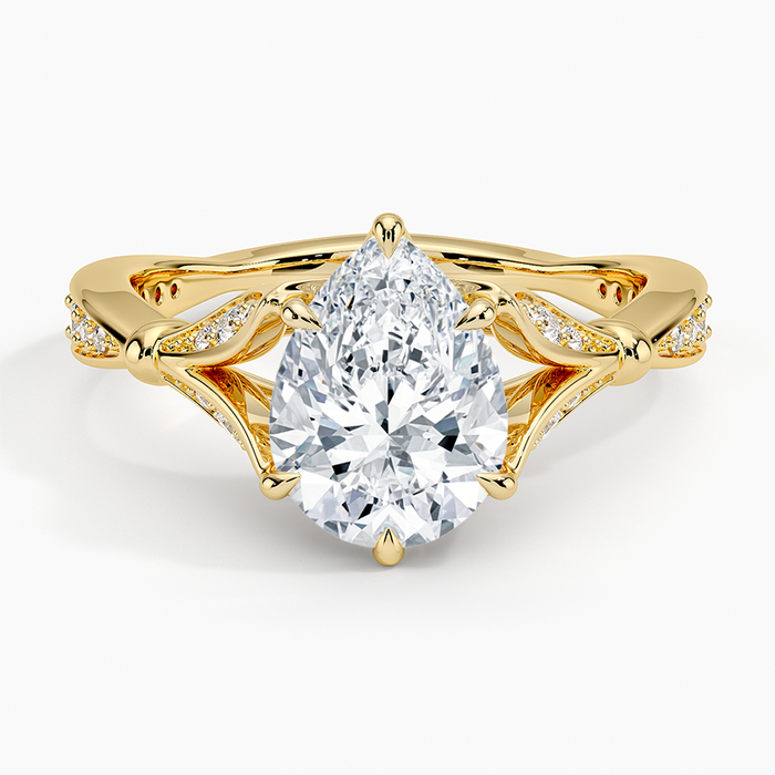 Pear cut moissanite pave leaf openwork engagement ring in yellow gold, top view