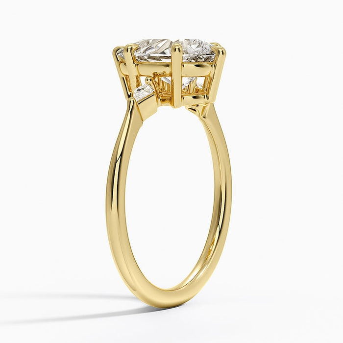 Side view showing the small pear side stones set point inward beside the centre