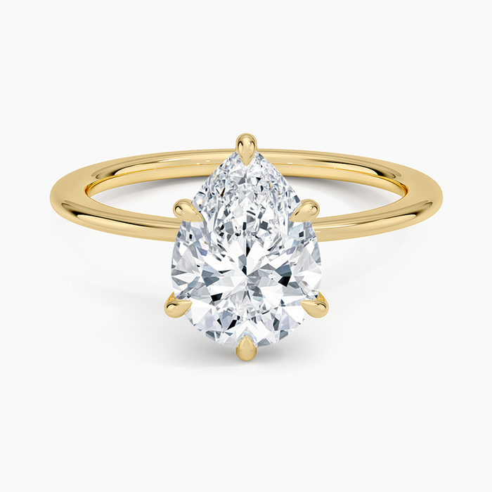 Pear cut moissanite plain band hidden halo engagement ring in yellow gold, top view