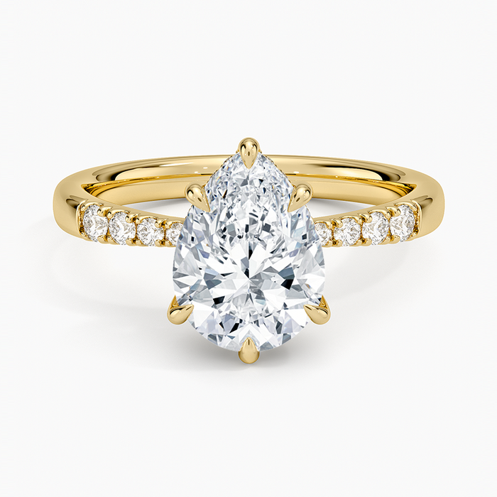 Pear cut moissanite shared prong hidden halo engagement ring in yellow gold, top view