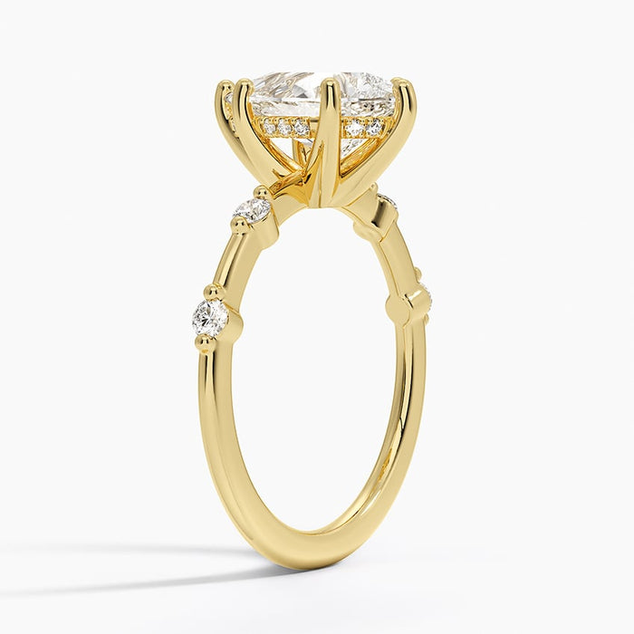 Side view showing individually claw set round accents with metal gaps between them