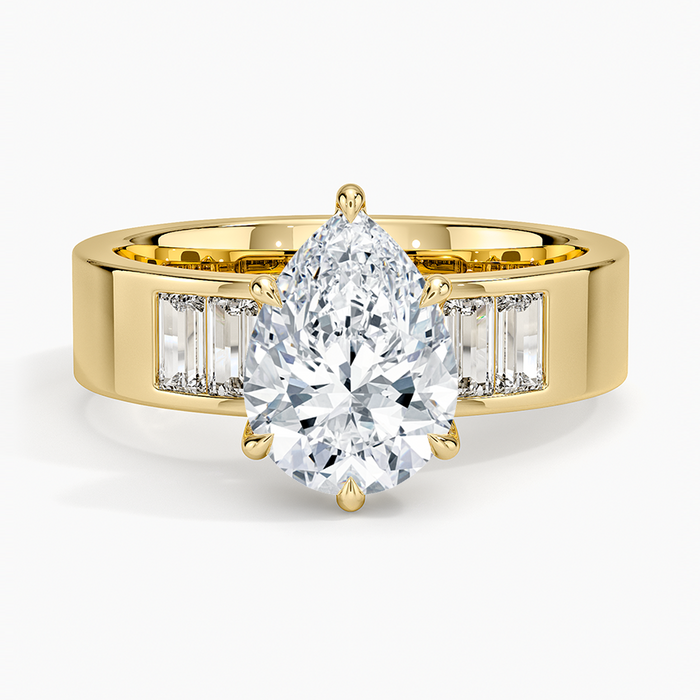 Pear cut moissanite ring on a wide flat band with channel set baguettes, top view
