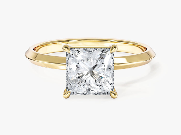Four claw princess cut lab grown diamond engagement ring with knife edge band in yellow gold, front view