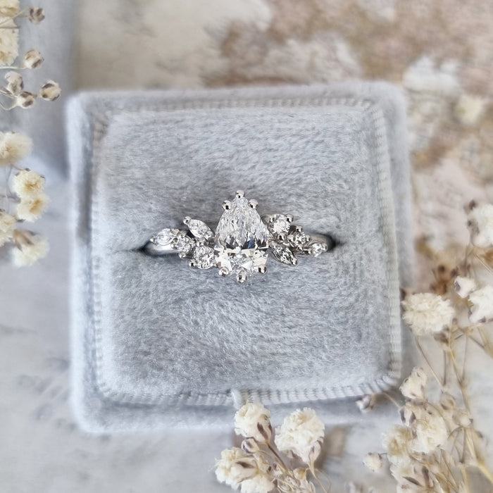 Pear cut moissanite mixed cut cluster engagement ring in eight fine claws in white gold