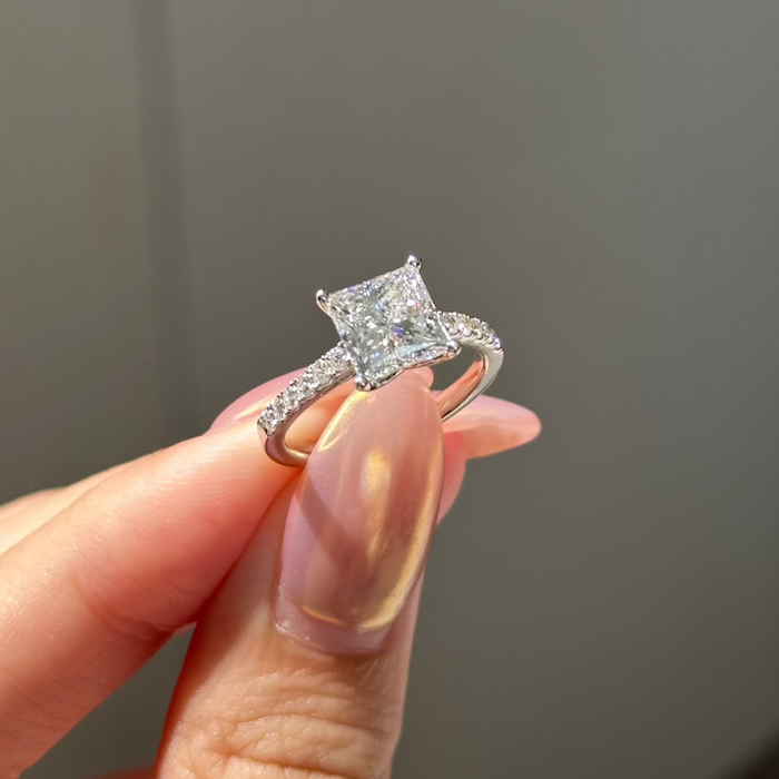 Princess cut moissanite engagement ring on a pave set white gold band
