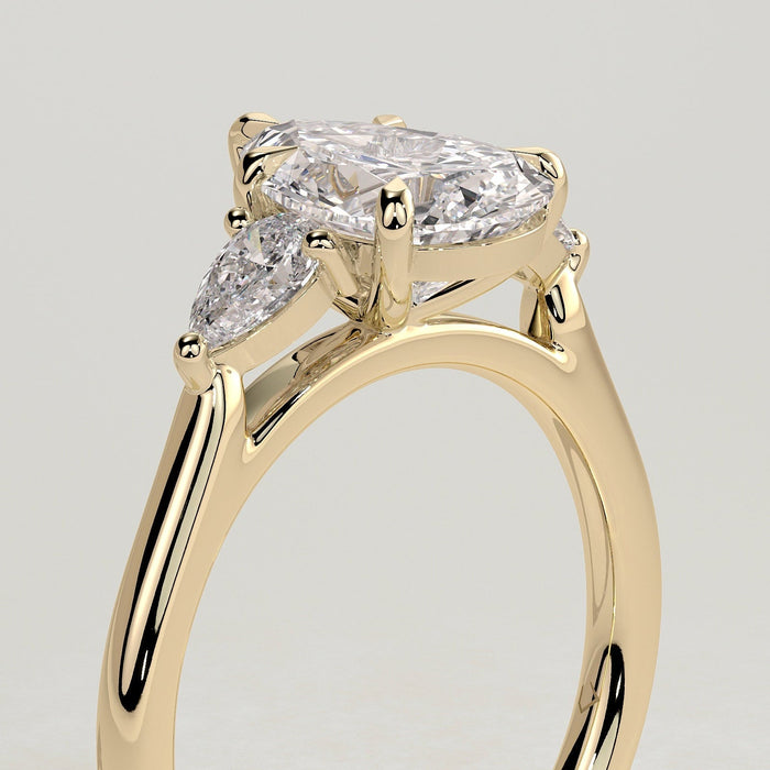 Pear cut moissanite three stone engagement ring with trillion side stones in yellow gold, view 2