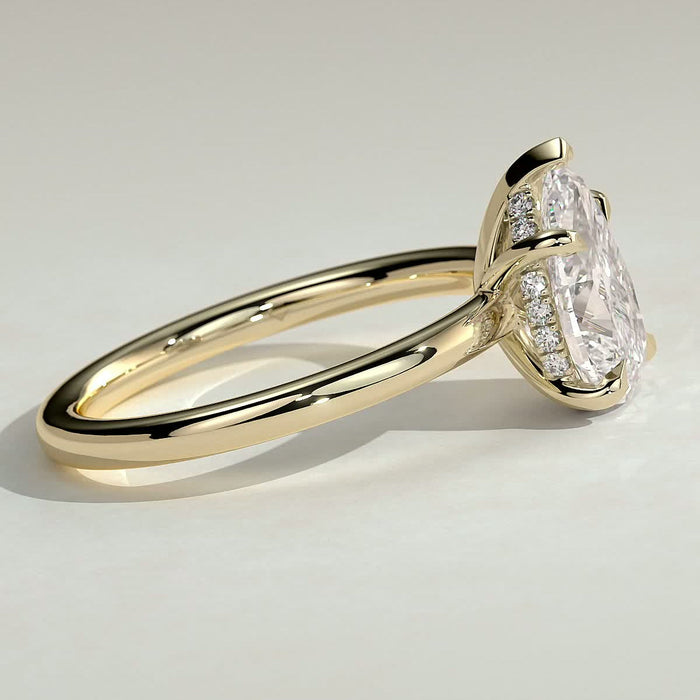 Pear cut moissanite V claw solitaire engagement ring on a domed yellow gold band, view 2