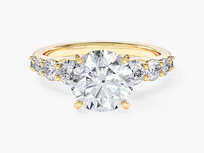 Round lab grown diamond engagement ring with graduated shared prong side stones in yellow gold, front view