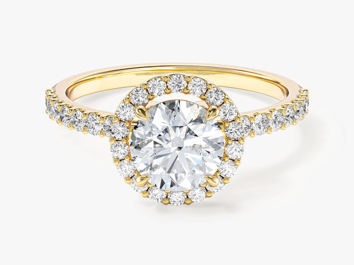 Round cut moissanite halo engagement ring with pave band in yellow gold, front view