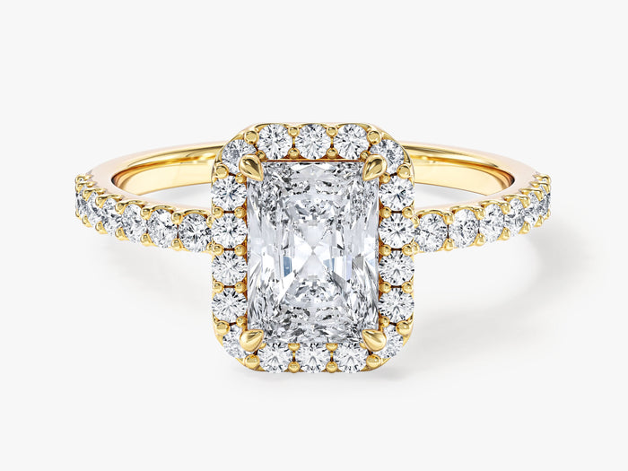 Elongated radiant lab grown diamond halo engagement ring with micro pave shoulders in yellow gold, front view
