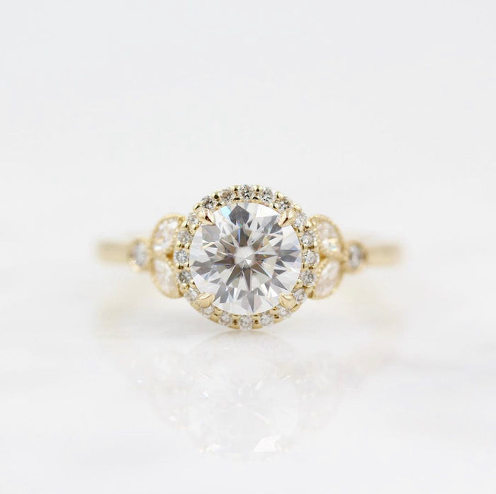 Round brilliant moissanite milgrain halo engagement ring with marquise panel shoulders in yellow gold