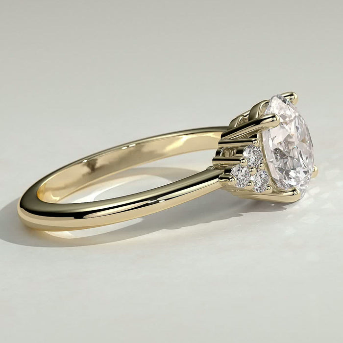Round brilliant moissanite engagement ring with triangular cluster shoulders in yellow gold, view 2
