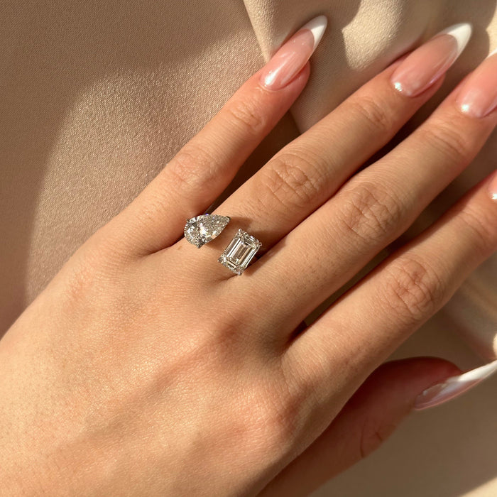Pear and emerald cut moissanite toi et moi engagement ring on a plain white gold band, view 2