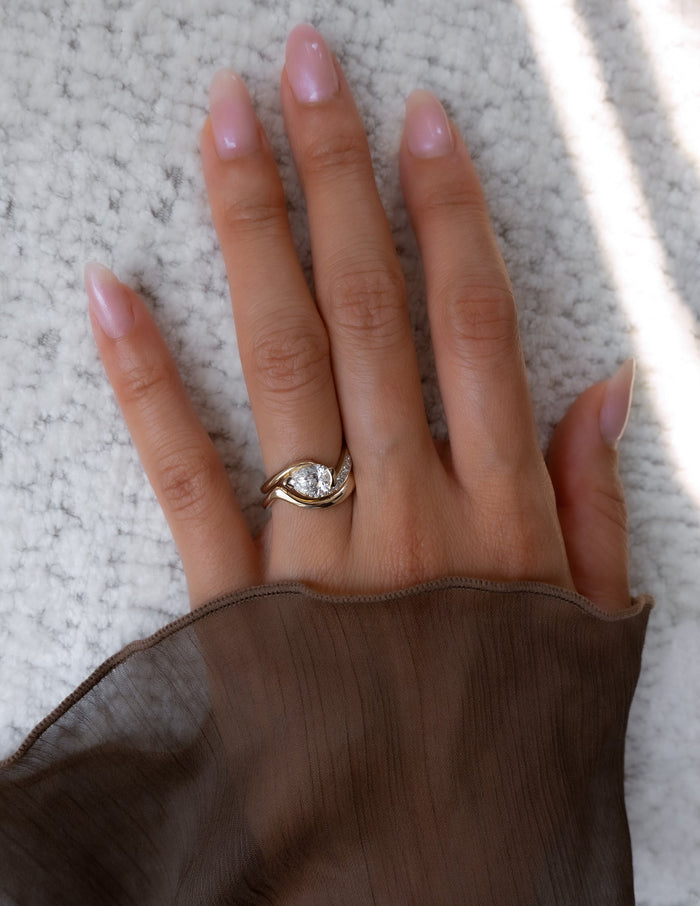 East-west pear lab grown diamond bridal set in yellow gold shown on the full hand